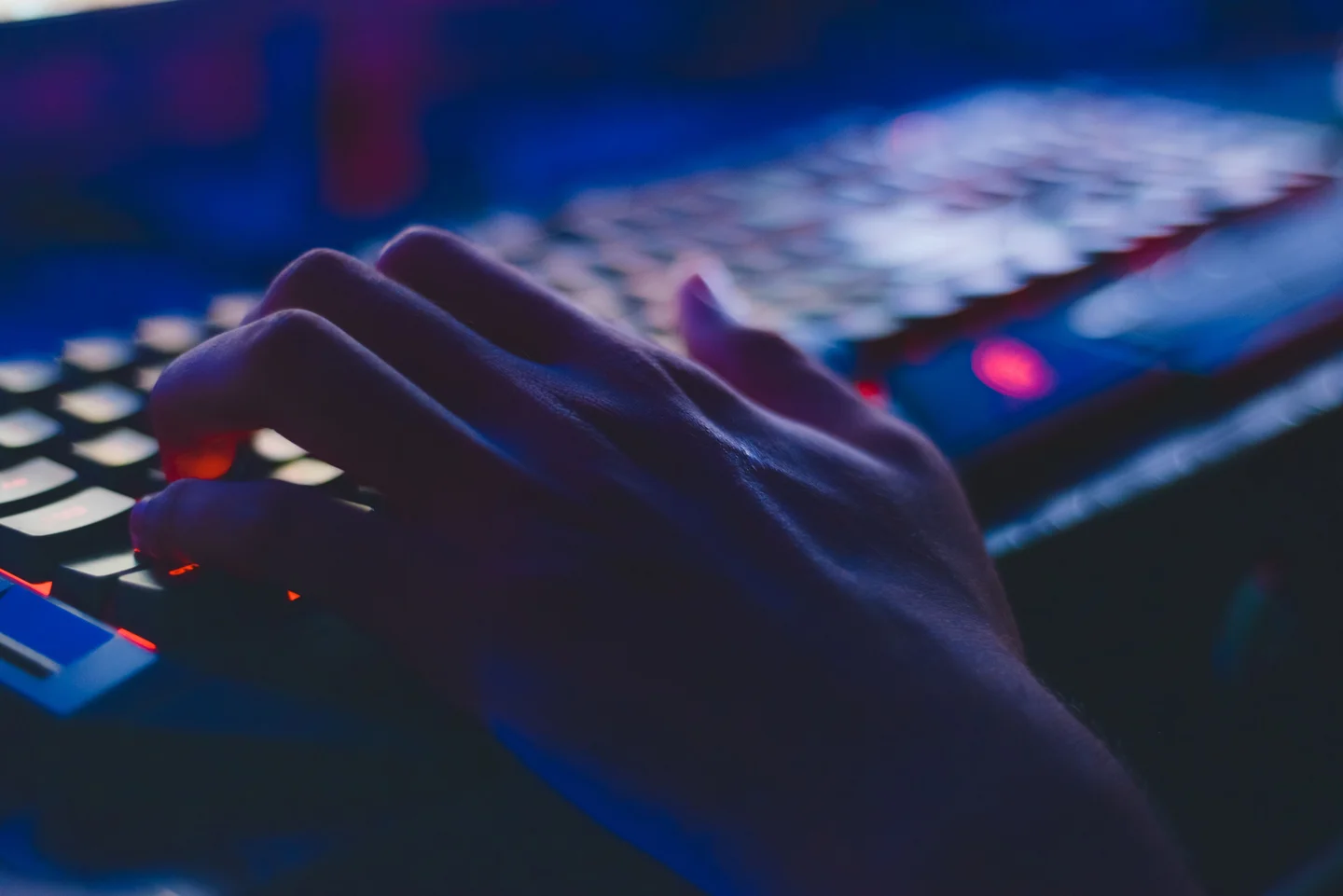 Hands working at a computer in a cybersecurity environment