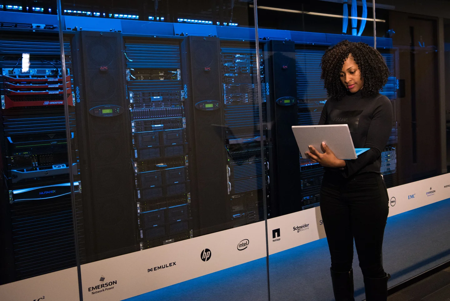 Engineer using a tablet in a data centre